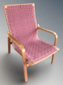 A Scandinavian bentwood lounge armchair with canvas webbed seat, width 63 cm.