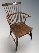 A 19th century elm spindle back windsor armchair, 53 cm wide.