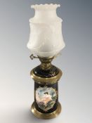 A brass and ceramic oil lamp with frosted shade, height 57 cm.