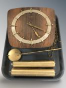 A Junghans wall clock with pendulum and weights.