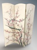 A reproduction oriental threefold screen depicting cherry blossom, each panel 41 cm x 153 cm.