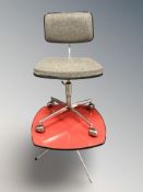 A 20th century chrome metal swivel rise and fall chair, and a melamine topped table.