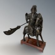 A Japanese Meiji period patinated bronze figure of a warrior on horseback, on wooden plinth,