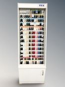 A YKK haberdashery shop display stand containing zips in various colours,