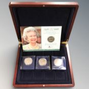 A coin collector's case containing a London Mint Queen Elizabeth II 80th birthday crown and three