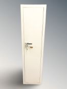 An enameled metal gun cabinet with internal ammunition compartment, with keys,
