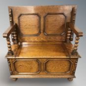 An early 20th century oak monk's bench,