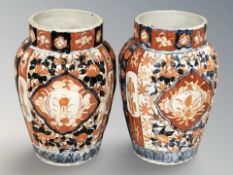 A pair of Japanese Meiji period Imari ribbed porcelain vases, height 24 cm.