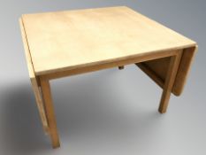 A Danish blonde oak drop leaf occasional table, width 85 cm unextended.