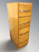 A vintage teak and plywood four drawer pedestal cabinet from a haberdashery,
