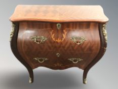 A continental king wood veneered bombe two-drawer cabinet with metal mounts,
