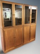 A pair of Danish glazed teak double door cabinets,