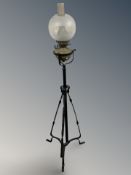 An Edwardian metal telescopic standard lamp with paraffin glass lamp.