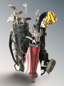 A golf trolley and two bags containing assorted irons and drivers, Wilson, etc.