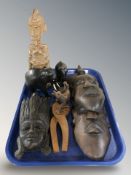 A group of African carved hardwood masks, ebony elephants, a nutcracker, figures, etc.