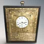 A continental wall clock in gilt surround, within an ebonised frame, overall 38 cm x 32 cm.