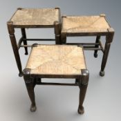 Three graduated joined oak rattan stools,
