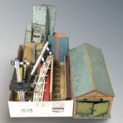 A group of tin plate model railway buildings.