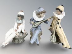 Three Nao figures of seated harlequin musicians.