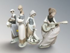 Two Lladro figures and two further Nao figures including seated musician, tallest 27 cm.