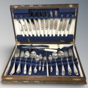 An oak canteen of stainless steel cutlery.