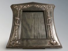 A decorative Art Nouveau photograph frame, decorated with two trees with the words 'Auld Lang Syne',