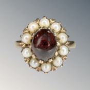 A 9ct yellow gold cabochon garnet and seed pearl ring, size O. CONDITION REPORT: 4.