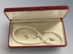 A single strand Mitsuko cultured pearl necklace with silver clasp,