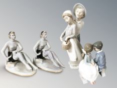 Two Nao groups of boys and girls and a pair of USSR porcelain figures of seated ice skaters.