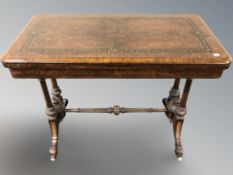 A Victorian Aesthetic Period figured walnut, ebonised and satinwood-inlaid turnover top card table,
