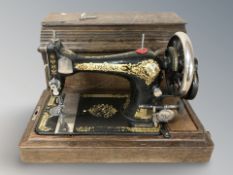 A Singer sewing machine in oak case.