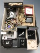 A collection of costume jewellery including bangles, gold plated pieces, pendants, peacock brooch,