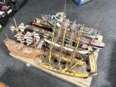 A group of partially built scale model ships,