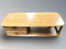 An Ercol light elm rectangular coffee table, fitted two drawers, 125 cm x 53 cm x 40 cm.