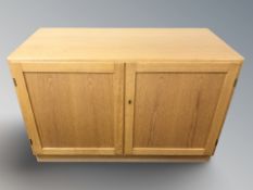A Scandinavian oak veneered double door low cabinet, 100 cm x 47 cm x 66 cm.
