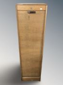 A tambour front pedestal cabinet with key,