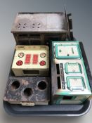 A group of vintage tin plate stoves and ovens.