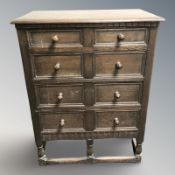 A stained oak four drawer chest,