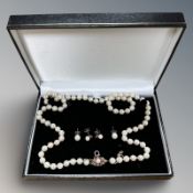A cultured pearl necklace with 9ct yellow gold clasp, studded with four rubies, length 65 cm,