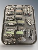A group of vintage tin plate locomotives and rolling stock.