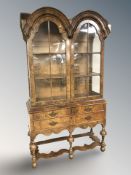 A Queen Anne style walnut domed double door display cabinet,