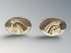 A pair of silver equestrian cuff links, overlaid with horse head motifs, Rosemary Hetherington,