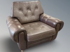 A late 20th century Danish buttoned brown leather lounge armchair,