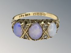 An 18ct yellow gold three stone opal ring, size M/N. CONDITION REPORT: 3.