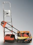 A Flymo electric mower and an aluminium folding step ladder