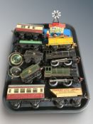 A group of vintage tin plate locomotives and rolling stock.