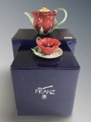 A Franz porcelain Poppy teapot and a further Poppy cup and saucer.