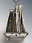 A garden trolley containing several walking sticks,