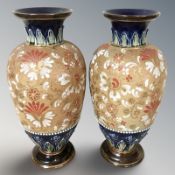 A pair of Royal Doulton Lambeth floral decorated vases, height 30 cm.