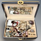 A leather jewellery box containing large silver ring, Venetian glass necklace,